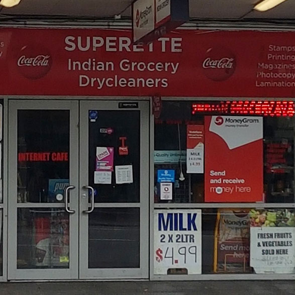 Gray Car in front of the Balmoral Drycleaners Store
